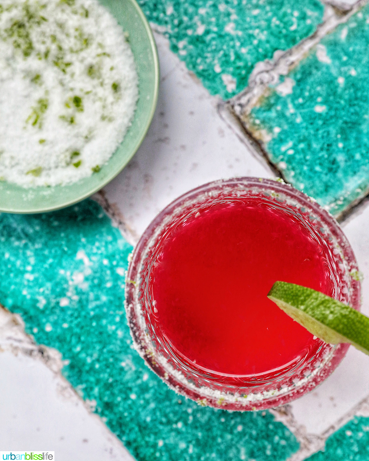glass of prickly pear margarita with lime slice garnish.