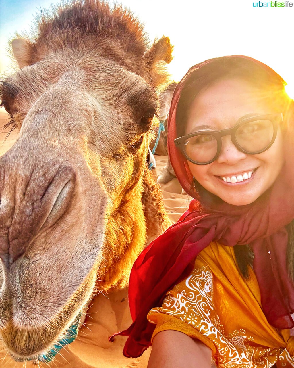 Marlynn Jayme Schotland with camel in the Sahara Desert, Morocco.
