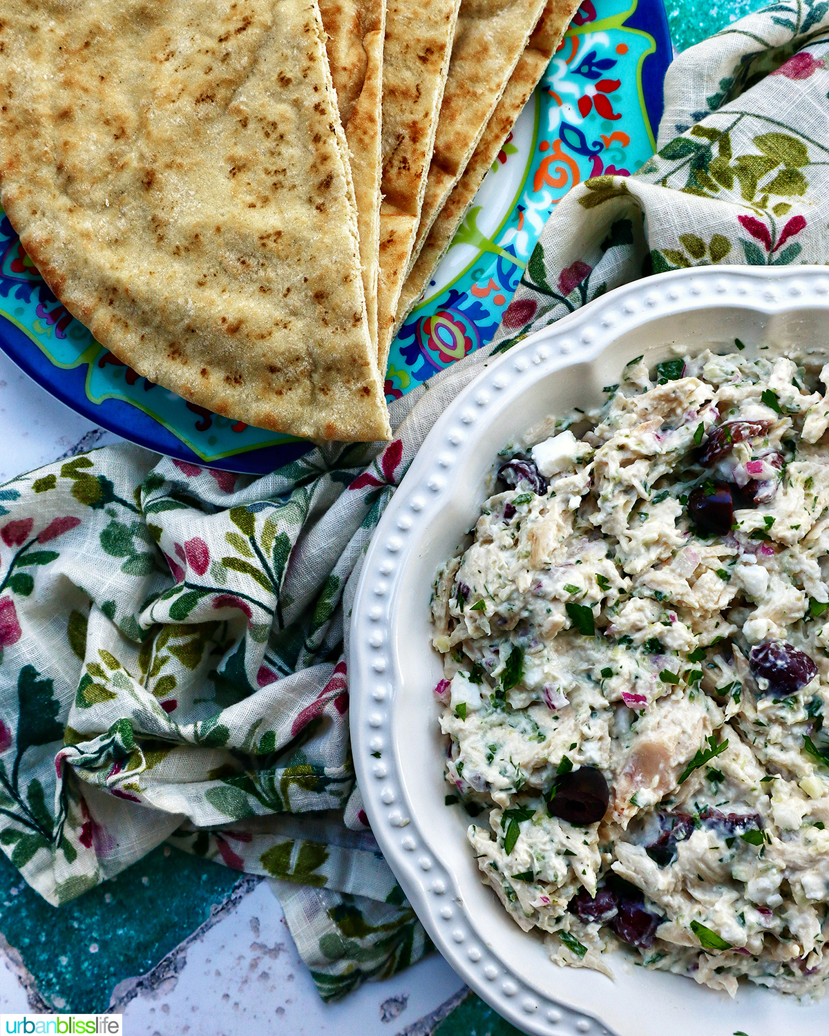 bowl of chicken tzatziki salad with side of pita bread.