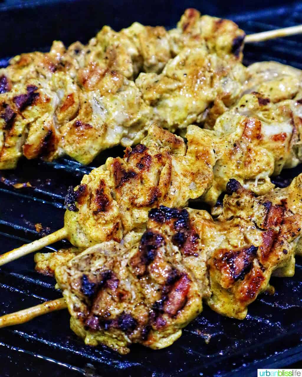 bang bang chicken skewers on a grill.