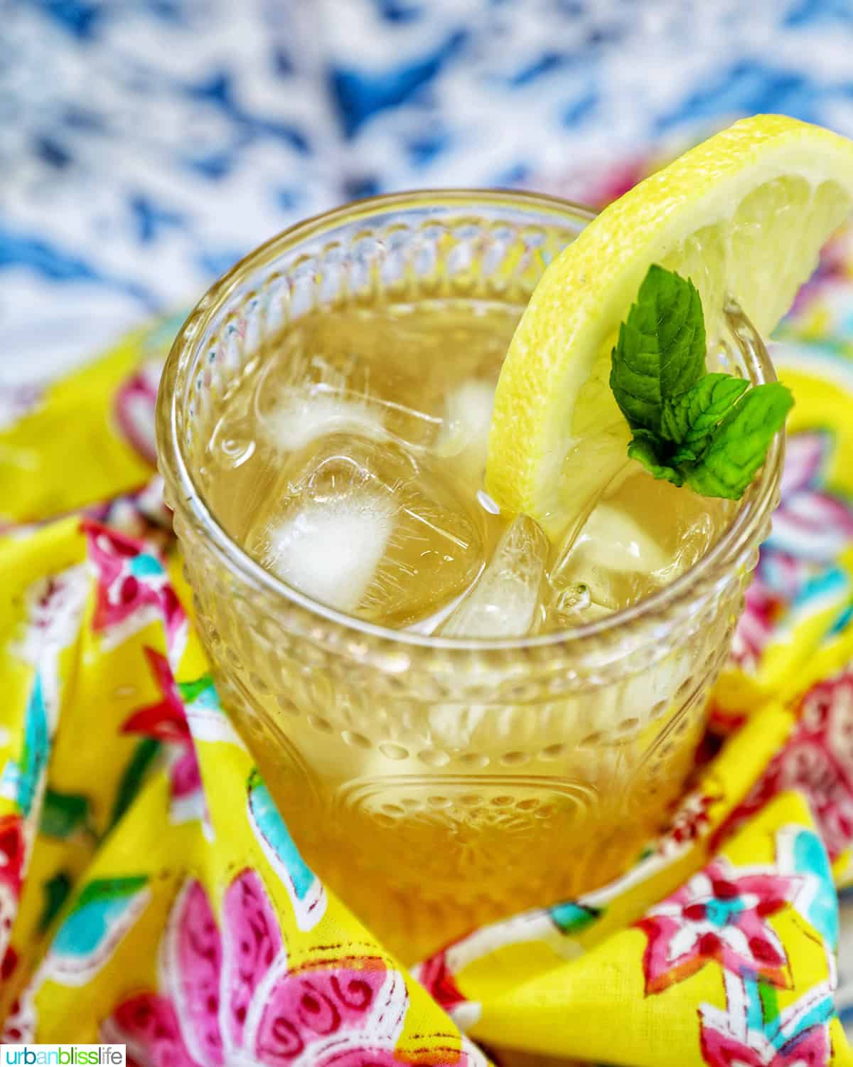 glass of bourbon lemonade on a bright colorful napkin.