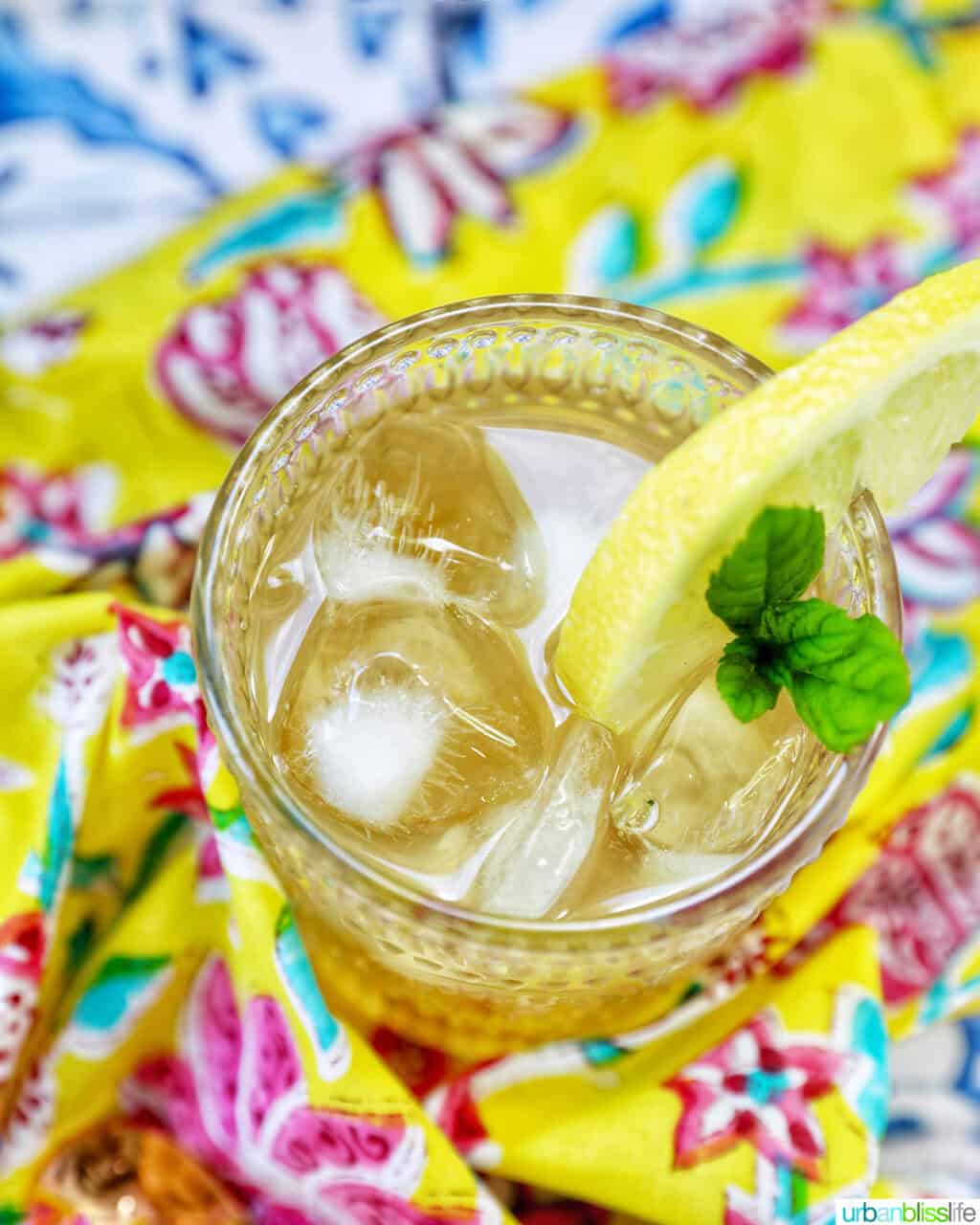 glass of bourbon lemonade on a bright colorful napkin.