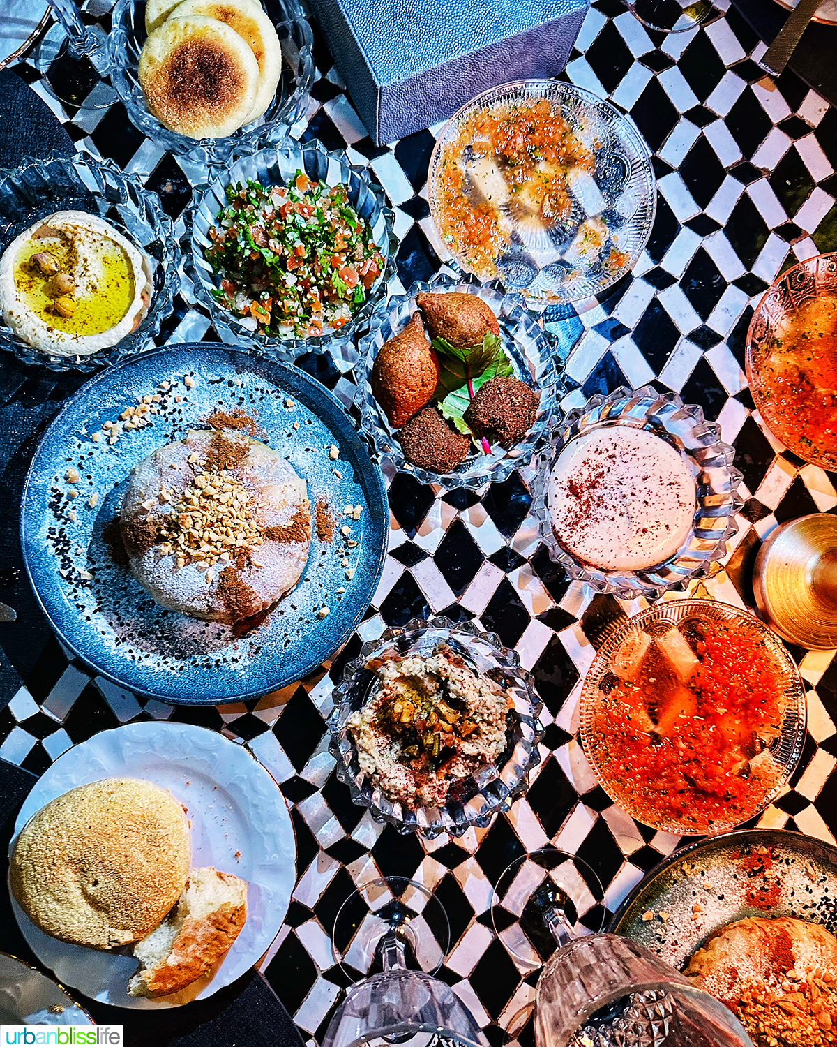 several colorful plates with Moroccan food.
