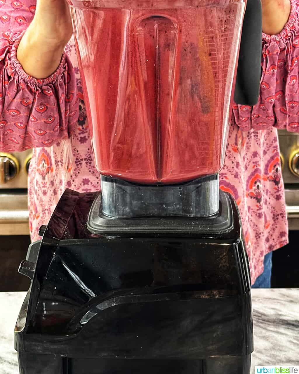 ingredients to make cherry popsicles in a blender.