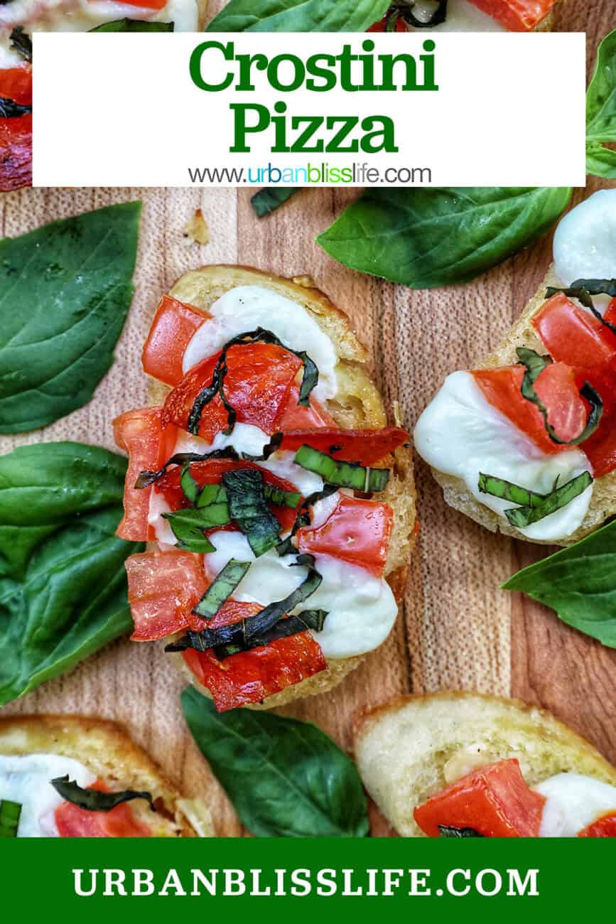 lots of crostini pizzas on a wooden board with title text overlay.