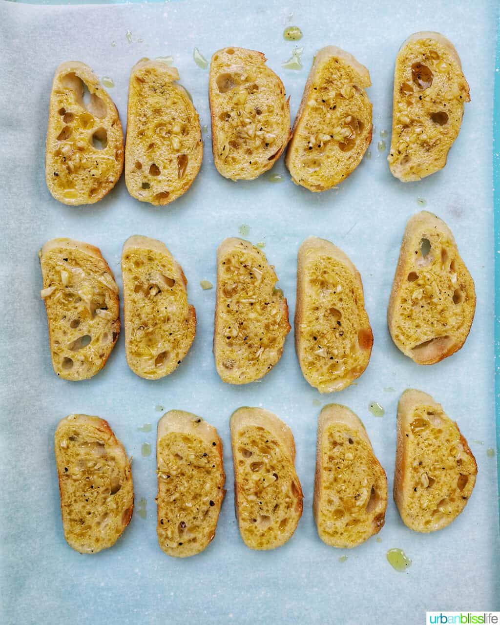 sliced crostini on a baking sheet.