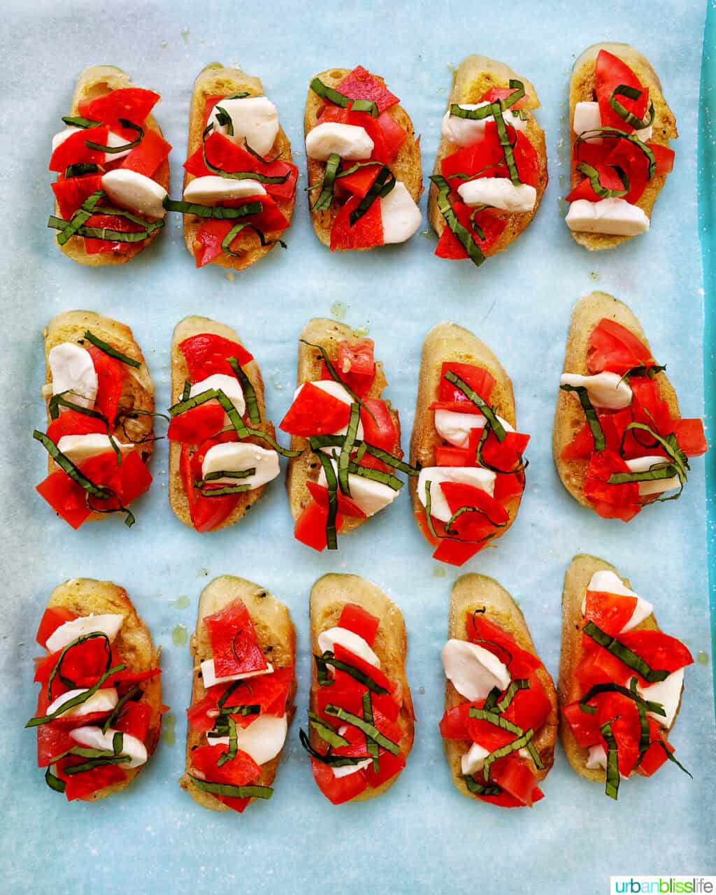 slices of crostini pizza on a baking sheet.