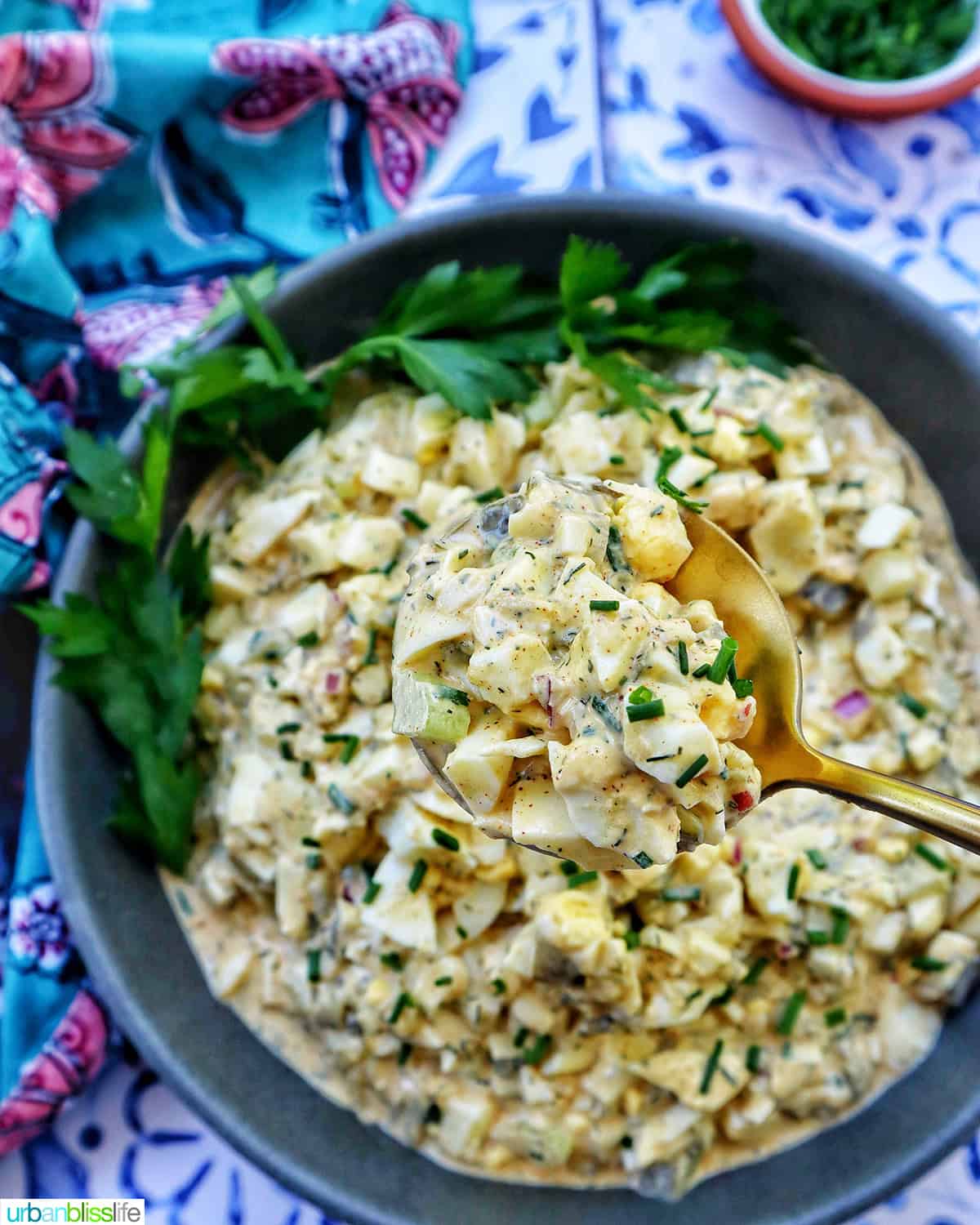 spoonful of egg salad over a bowl of dill pickle egg salad.