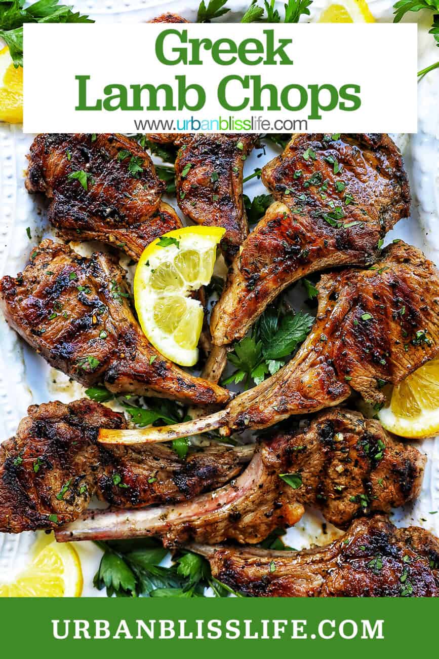Greek lamb chops on a white plate with herbs and lemon slices and title text overlay.