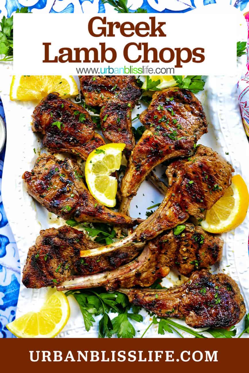 Greek lamb chops on a white plate with herbs and lemon slices and title text overlay.