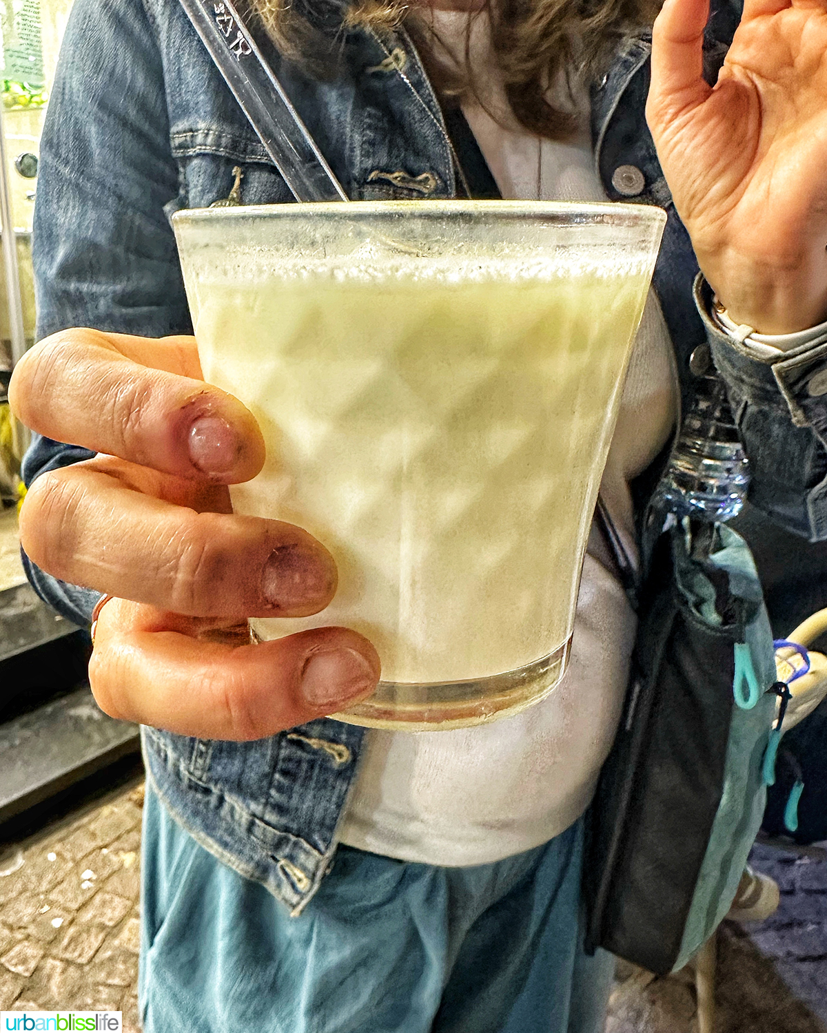 hand holding Moroccan raib yogurt.