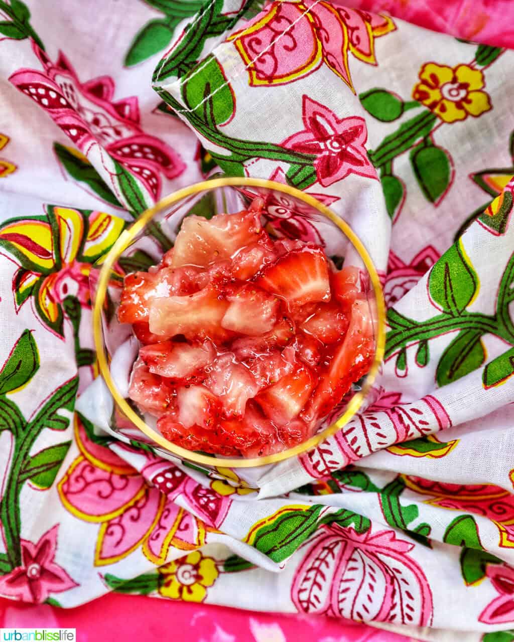 glass with muddled strawberries.