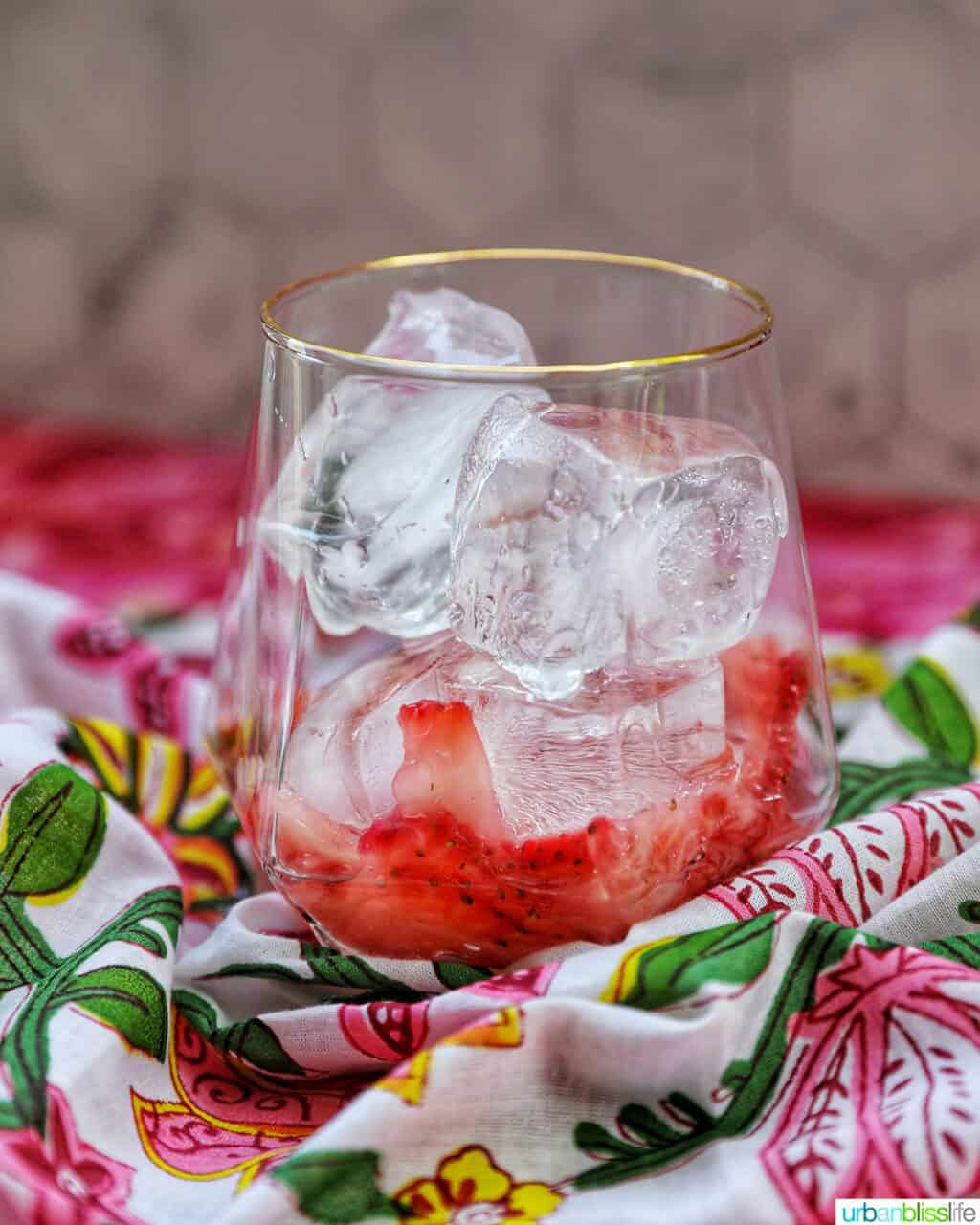 glass of ice and muddled strawberries.