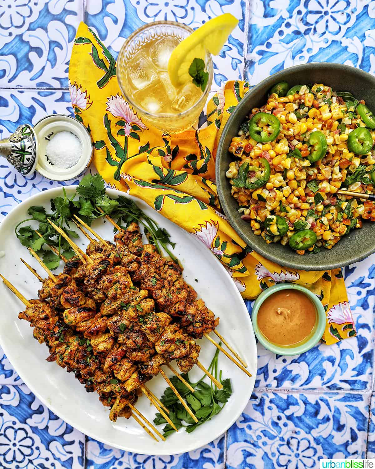tandoori chicken skewers with charred corn salad and bourbon lemonade.