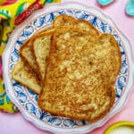 stack of high protein french toast on a colorful plate.