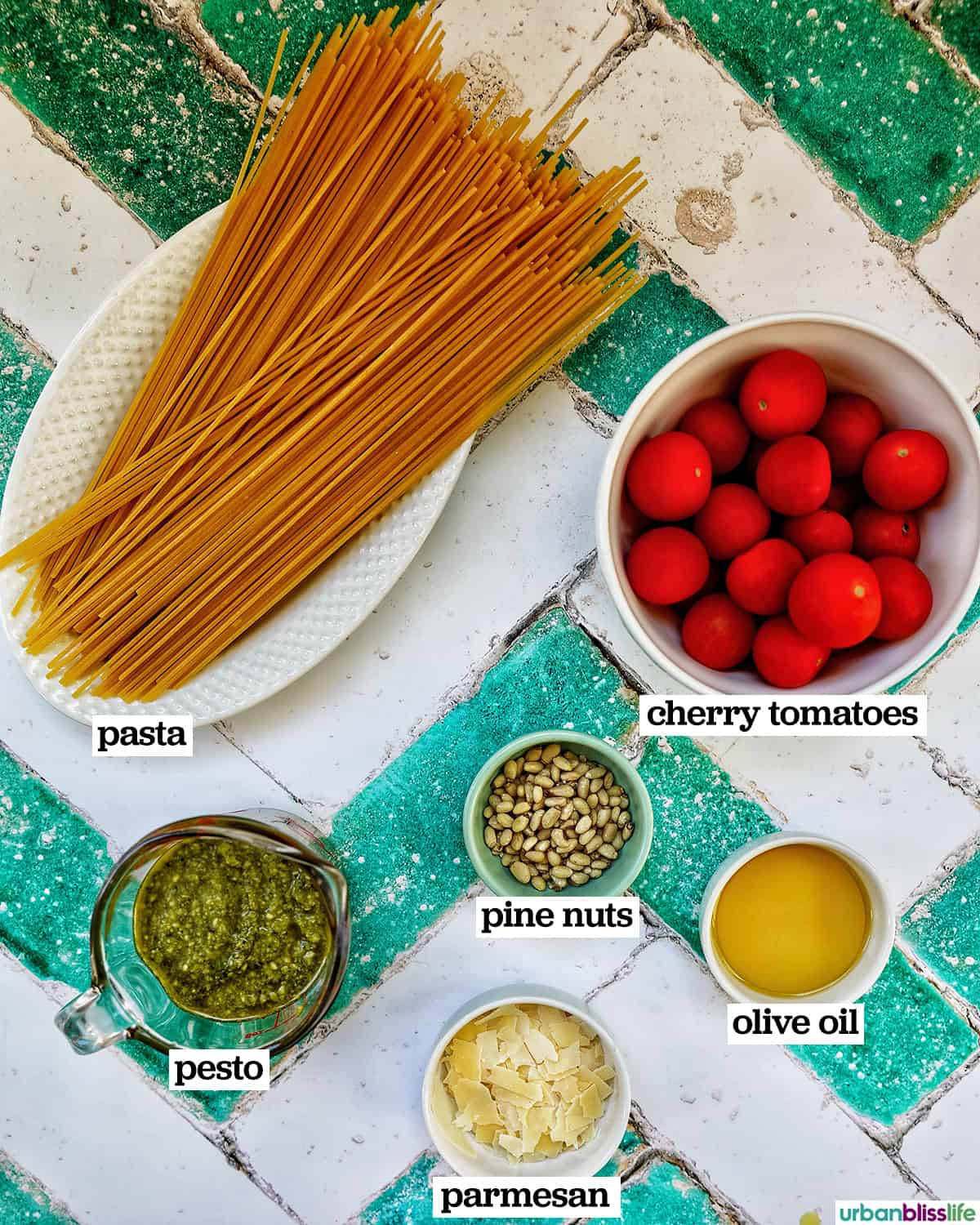 ingredients to make bowl of cherry tomato and pesto pasta.