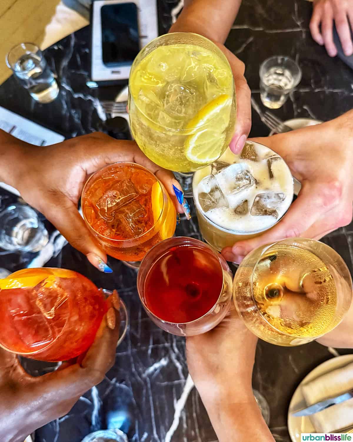 wine and cocktails cheers at Elena Restaurant in Montreal, Canada.