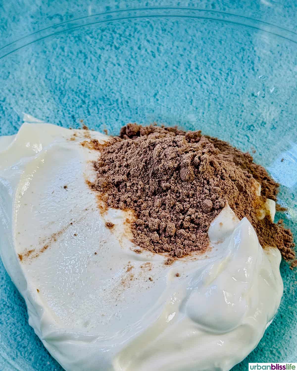 greek yogurt and chocolate protein powder in a bowl.