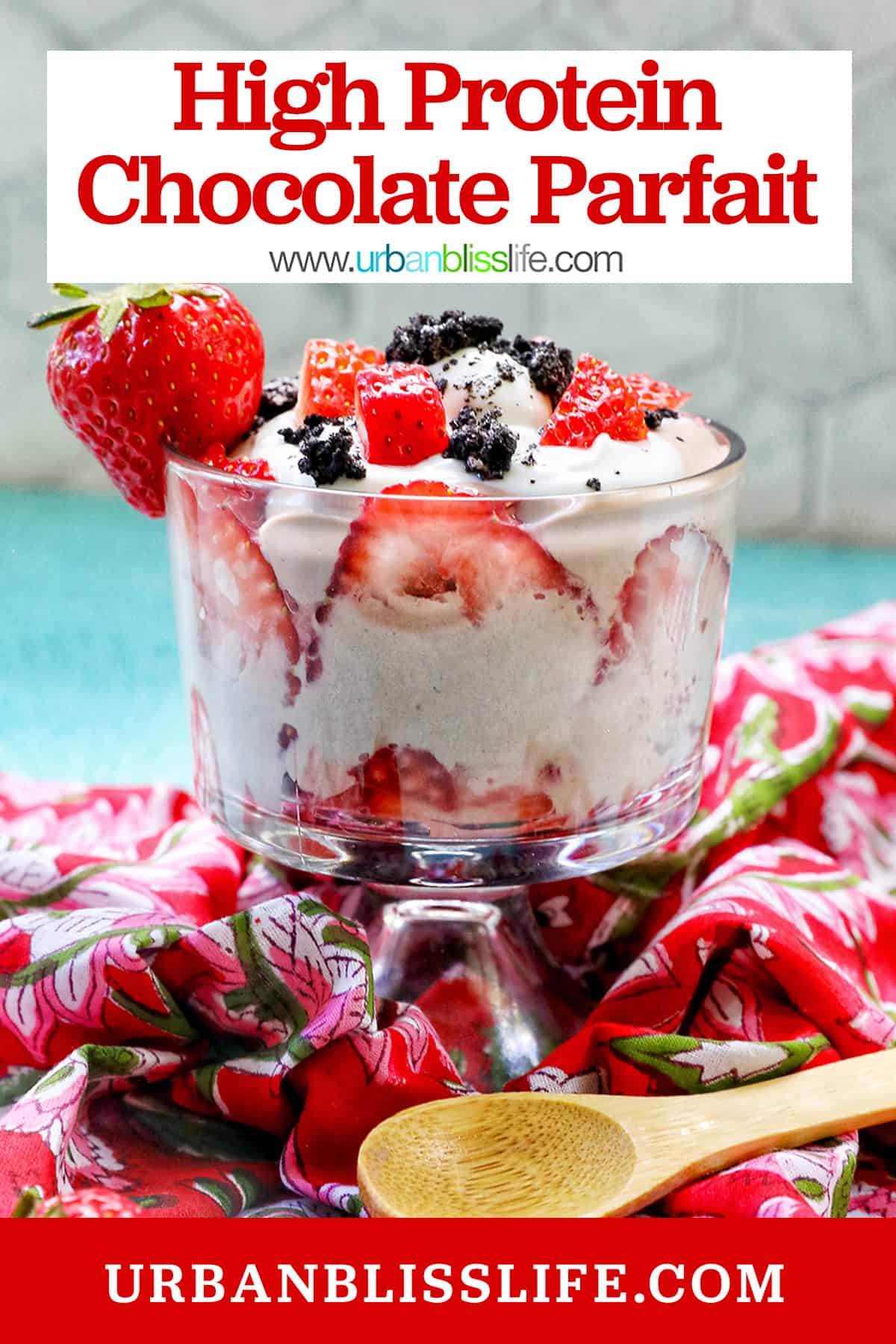 chocolate parfait with fresh berries on a red napkin with wooden spoon.