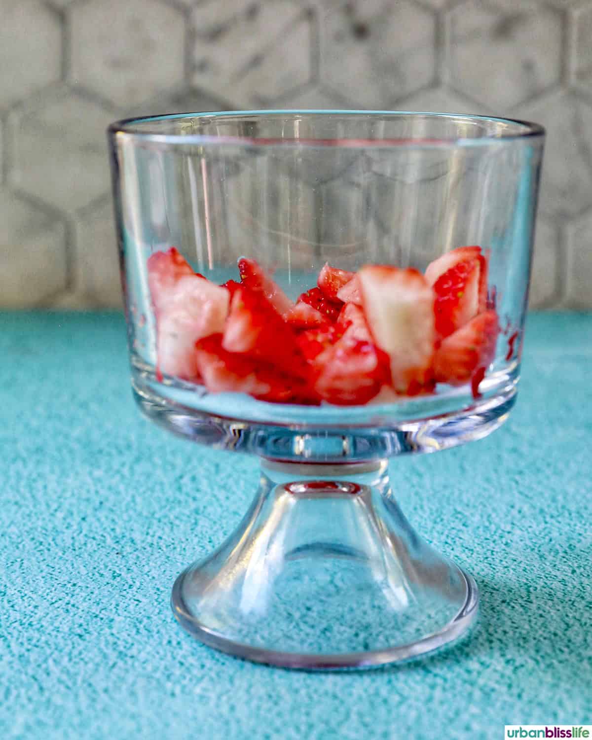 chopped strawberries in a glass bowl.