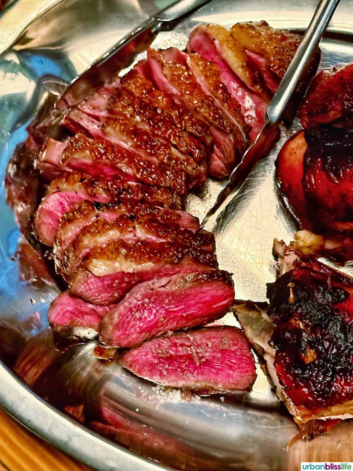 sliced ribeye on a platter.