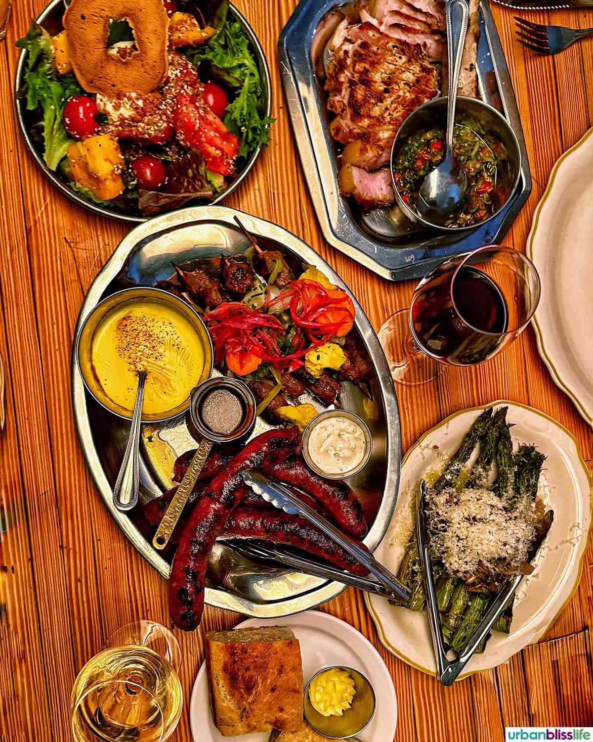platters of food on a wood table.