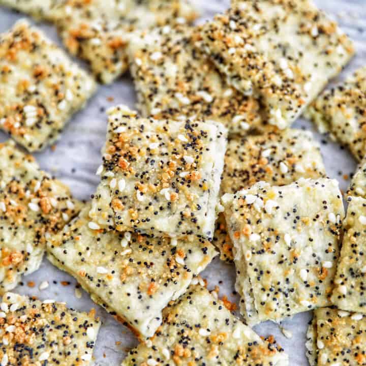 several sesame crackers laid out on a baking sheet.